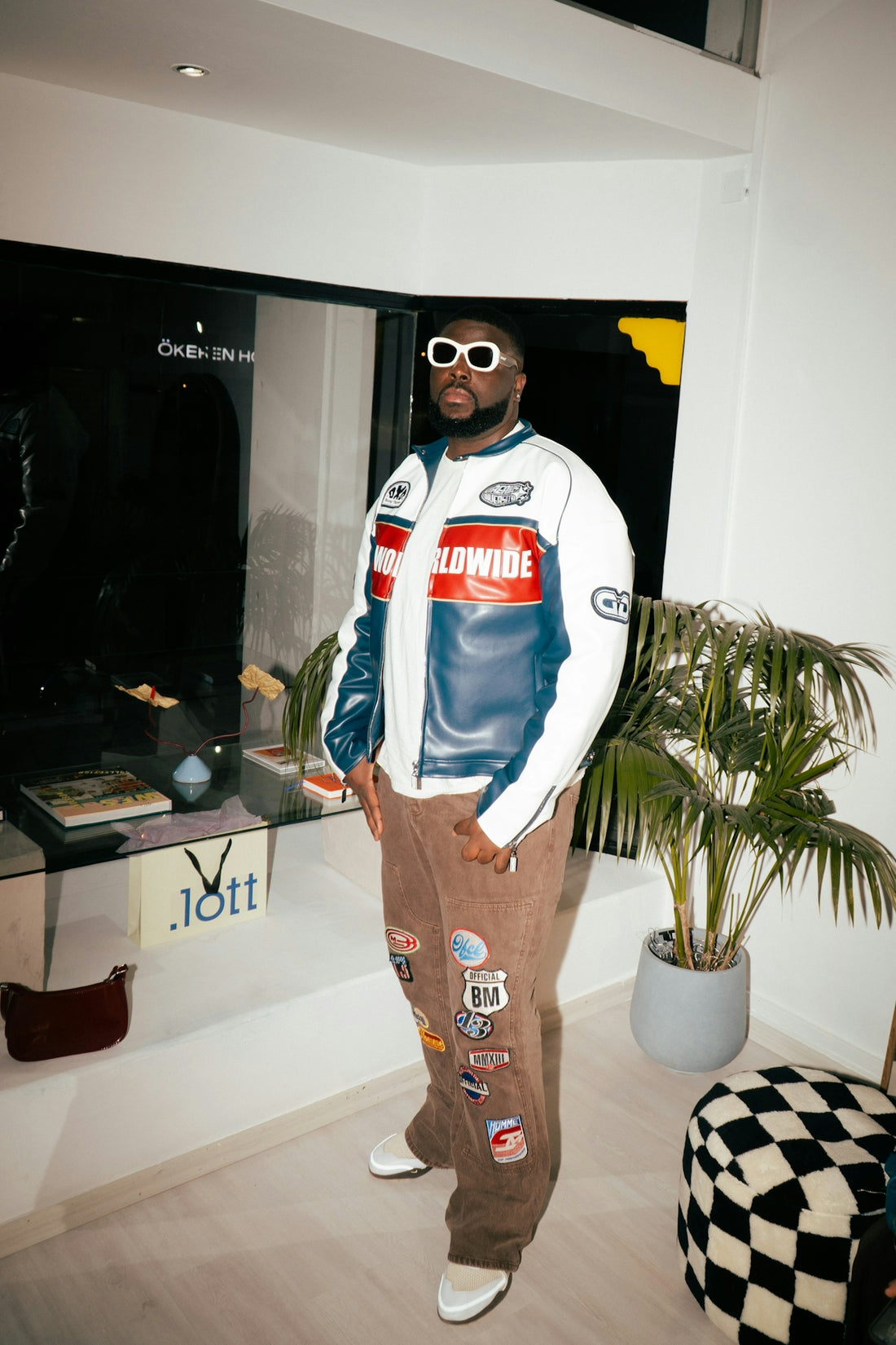 Man wearing a racing jacket and patched pants